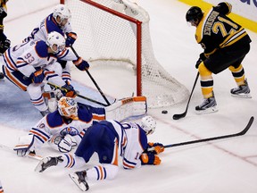 Oilers goalie Ben Scrivens sprawls to stop Bruins forward Loui Eriksson during the third period in Boston. (USA TODAY)