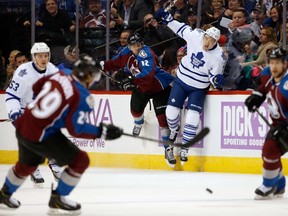 Jarome Iginla of the Avalanche puts a hit on James van Riemsdyk of the Maple Leafs during the first period in Denver on Thursday night. (Doug Pensinger/Getty Images/AFP)
