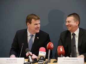 Canada's Foreign Minister John  Baird (L) and his Latvian counterpart Edgars Rinkevics react during a news conference in Riga April 25, 2014. REUTERS/Ints Kalnins
