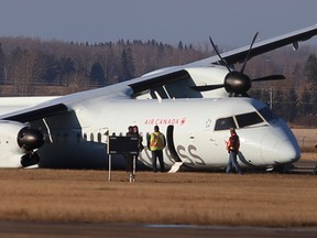 At least three people received minor injuries after Flight AC8481, an Air Canada Express Q400 aircraft, made an emergency landing at Edmonton International Airport on Thursday Nov 6, 2014. The plane was en route from Calgary to Grande Prairie with 71 passengers and four crew on board.  Edmonton, Alberta on Friday, November 7 , 2014. Perry Mah/Edmonton Sun