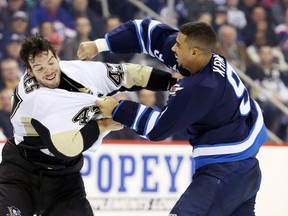 Pittsburgh Penguins defenseman Simon Despres (47) fights Winnipeg Jets forward Evander Kane (9) during the second period at MTS Centre.
