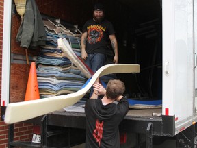 Erik Nordell, left, and Brad Armstrong with Capes Movers Ltd. transfer equipment out of the gym at the former St. Patrick's school building. The school board is getting the building ready for sale. (TYLER KULA/ THE OBSERVER/ QMI AGENCY)