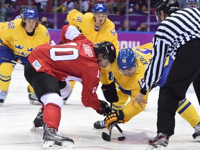 Canada's Patrick Sharp (left) faces off against Sweden's Marcus Kruger during the men's gold medal final at the Bolshoy Ice Dome at the Sochi Winter Olympics on Feb. 23, 2014. The NHL has not committed to the 2018 games in Pyeongchang, South Korea. (Ben Pelosse/QMI Agency/Files)