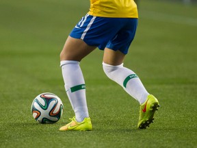 A Brazil player moves the ball across the artificial turf against China during FIFA U-20 Women’s World Cup play at Commonwealth Stadium in Edmonton Alta., on Aug. 5, 2014. (IAN KUCERAK/QMI Agency)