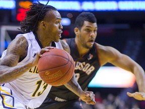 Stephen McDowell of the London Lightning gets around the corner on Kevin Loiselle of the Windsor Express during London?s home opener at Budweiser Gardens last Saturday. (MIKE HENSEN, The London Free Press)