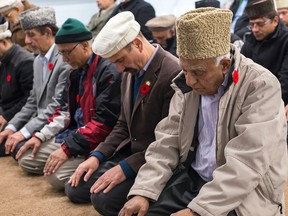 Members of the Baitun Naseer Mosque in Cumberland engaged in prayer during the Muslims for Remembrance Day event on Friday. DANI-ELLE DUBE/OTTAWA SUN