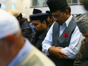 Mosque members wear their poppies as they take in Islamic Friday Prayer during the 4th Annual Nation-Wide “Muslims for Remembrance Day” Campaign to Raise Funds for Canadian Veterans at Baitul Islam Mosque on Friday November 7, 2014. Dave Abel/Toronto Sun