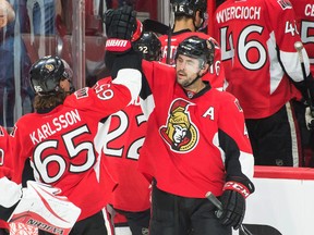 Chris Phillips gives a high-five to Erik Karlsson, the only Senator who is averaging more more ice time than the 36-year-old veteran. (USA TODAY SPORTS)
