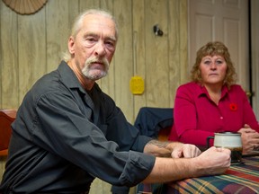 Lanny Stilwell sits with his wife, Mickey Neale, in the kitchen of their home where, while doing the dishes in 2000, Stilwell was injured when a dutch oven shattered in his hands, severely injuring his right hand. Stilwell sued Corning Inc. and World Kitchen Inc., winning a $1.15 million settlement after 14 years of legal battles in a case which was decided in the Ontario Court of Appeal.  The couple are pictured here in their Beachville, Ontario home on November 7, 2014. (CRAIG GLOVER/QMI Agency)