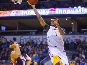 London Lightning?s Maurice Bolden goes baseline over Kevin Loiselle of the Windsor Express during their home opener at Budweiser Gardens on Nov. 1. Bolden had 19 points and 16 rebounds in the game. (MIKE HENSEN, The London Free Press)