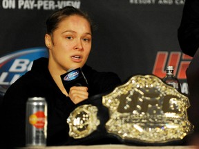 UFC women's bantamweight champion Ronda Rousey answers questions from reporters after defending her title against Sara McMann in the first round of the main event of UFC 170 at Mandalay Bay on February 22, 2014. (Stephen R. Sylvanie/USA TODAY Sports)