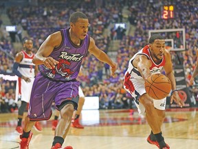 Raptors’ Kyle Lowry goes for the ball against Wizards’ Garrett Temple during Friday night’s game. (MICHAEL PEAKE/Toronto Sun)