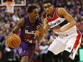 Raptors’ Lou Williams (left) drives against against Wizards’ Otto Porter during Friday night’s game in Toronto. (MICHAEL PEAKE/TORONTO SUN)