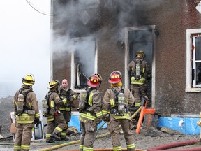 JOHN LAPPA/THE SUDBURY STAR/QMI AGENCYFirefighters battle a house fire on Alder Street in Sudbury on Thursday morning.