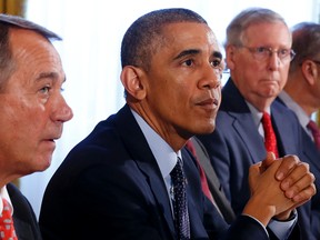 U.S. President Barack Obama hosts a luncheon for bi-partisan Congressional leaders in the Old Family Dining Room at the White House in Washington, November 7, 2014. From left to right are Speaker of the House John Boehner, Obama, Senate Minority Leader Mitch McConnell. (REUTERS/Larry Downing)