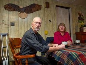 Lanny Stilwell sits with his wife, Mickey Neale, in the kitchen of their home where, while doing the dishes in 2000, Stilwell was injured when a dutch oven shattered in his hands, severely injuring his right hand.  Stilwell sued Corning Inc. and World Kitchen Inc., winning a $1.15 million settlement after 14 years of legal battles in a case which was decided in the Ontario Court of Appeal.  The couple are pictured here in their Beachville, Ontario home on Friday November 7, 2014.
CRAIG GLOVER The London Free Press / QMI AGENCY