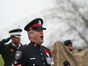 Ottawa police Staff Sgt. Brad Hampson belts out O Canada during the Strandherd-Armstrong bridge re-naming ceremony and plaque unveiling. Tne bridge will now be known as the Vimy Memorial Bridge -- a name close to Hampson's heart, whose grandfather fought at Vimy Ridge during the First World War.
DOUG HEMPSTEAD/Ottawa Sun
