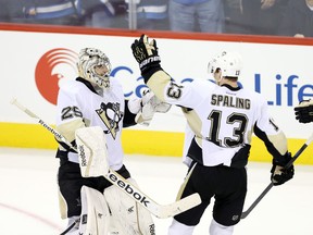 Pittsburgh Penguins goalie Marc-Andre Fleury (29) celebrates with teammate Nick Spaling (13) after defeating the Winnipeg Jets at MTS Centre. (Bruce Fedyck/USA TODAY Sports)