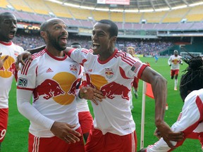 New York Red Bulls forward Thierry Henry (left) and defender Roy Miller (7) celebrate after a New York Red Bulls goal against the D.C. United during the second half at Robert F. Kennedy Memorial. (Brad Mills-USA TODAY Sports)