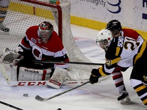 Kingston Frontenacs Samuel Schutt gets a shot off on Ottawa 67's Liam Herbst during Ontario Hockey League action at the Rogers K-Rock Centre in Kingston on Saturday November 8 2014. 
(IAN MACALPINE)-KINGSTON WHIG-STANDARD/QMI AGENCY