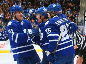 Maple Leafs players celebrate after defenceman Jake Gardiner (left) set up Leo Komarov for the game-winner against the New York Rangers on Saturday night at the ACC. (Getty Images/AFP)