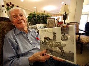Second World War veteran Fred Bray, 97, holds a picture of his father Cpl. Frederick Charles Bray who fought in the Boer War. Perry Mah/Edmonton Sun
