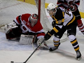 Kingston Frontenacs Juho Lammikko gets a shot off on Ottawa 67's goalie Liam Herbst  during Ontario Hockey League action at the Rogers K-Rock Centre in Kingston on Saturday November 8 2014. (IANMACALPINE)-KINGSTON WHIG-STANDARD/QMI AGENCY