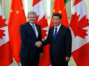 Canadian Prime Minister Stephen Harper shakes hands with Chinese President Xi Jinping (R) at the Great Hall of the People in Beijing November 9, 2014. REUTERS/Petar Kujundzic