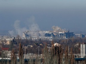 Smoke rises above a new terminal of the Sergey Prokofiev International Airport after the recent shelling during fighting between pro-Russian separatists and Ukrainian government forces in Donetsk, eastern Ukraine, November 9, 2014. REUTERS/Maxim Zmeyev