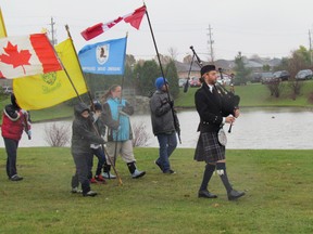 Piper Deven MacKinnon leads the 23rd Sarnia Scouting Group colour party during Saturday's dedication of a living memorial. (NEIL BOWEN, The Observer)