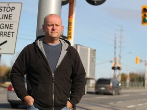 Paul Rodie is demanding safety signage changes and charges against an OC Transpo driver after a bus was caught under a railway safety arm on Fallowfield Rd. Rodie's daughter was one of the survivors of last year's train-bus crash.
DOUG HEMPSTEAD/Ottawa Sun/QMI AGENCY