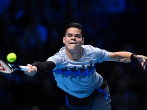 Milos Raonic of Canada stretches for a return during his men's singles tennis match against Roger Federer of Switzerland at the ATP World Tour Finals at the O2 Arena in London November 9, 2014. (REUTERS/Dylan Martinez)