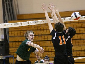 Nico Presot, left, of the Lockerby Vikings, spikes the ball past Lasalle Lancers playersTyrus Cucalick, middle, and Matthew Fragameni during the senior boys division 1 volleyball championship at Cambrian College on Saturday.