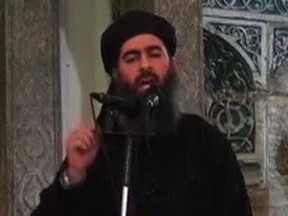 A man purported to be the leader of the Islamic State Abu Bakr al-Baghdadi in a still image taken from a video recording posted on the Internet on July 5, 2014.  REUTERS/Social Media Website via Reuters TV