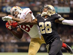 49ers wide receiver Anquan Boldin (left) hauls in a touchdown as he is defended by the Saints’ cornerback Keenan Lewis yesterday in New Orleans. (USA TODAY)