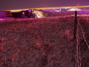 About 18 coal-carrying cars derailed from the train tracks just east of Lundbreck, Alta. on Sunday, Nov. 9 around 8:30 p.m. Mangled train cars and the dark fuel littered the ground a couple hundred metres from a home. No injuries or danger to the public were reported. John Stoesser photos/QMI Agency.