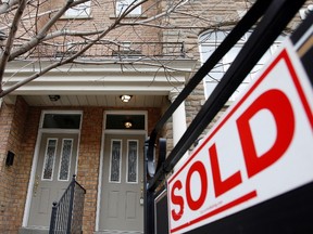 A "sold" sign is displayed in front of a home in Toronto in this December 15, 2009 file photograph. (REUTERS/Mike Cassese/Files)