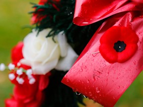 Raindrops collect on a wreath adorned with a poppy at Little Lake Cemetery in Peterborough on Saturday. (Clifford Skarstedt/QMI Agency)