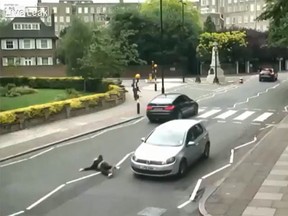A car hits a woman at the Beatles' famous Abbey Road crossing in London in this YouTube screengrab. (LiveLeak/YouTube)