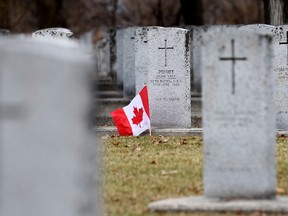 A Canadian flag sits beside the grave of Private John Bell, of the 27th Battalion, Canadian Expeditionary Force, in the Field of Honour at Brookside Cemetery last year. (Brian Donogh/Winnipeg Sun file photo)