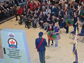 Emmajot Sran and Robin Arquement present the Legion’s Sergeant-at-Arms Fred White with a wreath during a special Remembrance ceremony put on by students for Lieutenant Governor Donald Ethell and local veterans on Nov. 5.  John Stoesser photo/QMI Agency