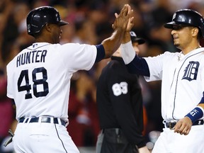 Detroit Tigers right fielder Torii Hunter (48) and first baseman Victor Martinez (41) celebrate after both scoring in the seventh inning against the Cleveland Indians at Comerica Park on Sep 12, 2014 in Detroit, MI, USA. (Rick Osentoski-USA TODAY Sports)
