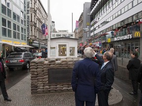 U.S. Secretary of State John Kerry (front L) visits Checkpoint Charlie with U.S. Ambassador to Germany John Emerson in Berlin, October 22, 2014. REUTERS/Brian Snyder