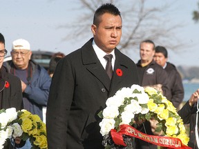 Cpl. Leif Kiyoshk, left, and Cpl. Seneca Day lay wreaths in memory of Cpl. Nathan Cirillo and WO Patrice Vincent during the Walpole Island Remembrance Day ceremony held on Monday at the Walpole Island cenotaph