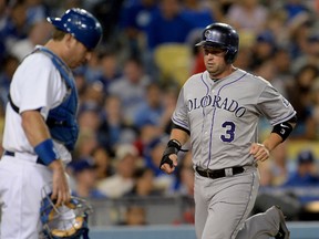 Los Angeles Dodgers catcher A.J. Ellis (17) looks on as Colorado Rockies right fielder Michael Cuddyer (3) scores a run in the fourth inning of the game at Dodger Stadium on Sep 27, 2014 in Los Angeles, CA, USA. (Jayne Kamin-Oncea/USA TODAY Sports)