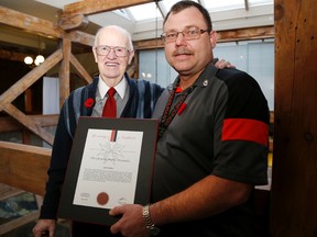Emily Mountney-Lessard/The Intelligencer
Jack Foster, left, stands with John Harpell after Harpell received the St. John Ambulance life-saving award during Monday's city council meeting. Just one day after completing a St. John Ambulance first aid and CPR course, Harpell saved Foster's life at a local restaurant.