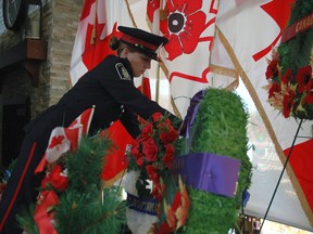St. Thomas Police Service Const. Tanya Calvert lays a wreath Monday at a Remembrance Day ceremony at Valleyview Home. About 100 people gathered for the ceremony, including six veterans who are residents of the home.  (Ben Forrest, Times-Journal)