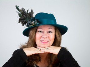 This hat by designer Annette Spracklan, owner of Hats with Class, features green velvet ribbon in a mesh with two large velveteen flowers and a spray of feathers. It sells for $125. (CRAIG GLOVER, The London Free Press)