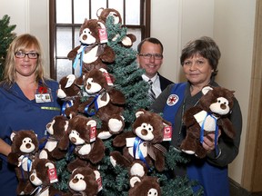 Nurse practitioner Lynn Newton, Dr. Richard van Wylick and auxiliary volunteer Heather Breck at the launch of the Kingston General Hospital Auxiliary Teddy Bear Campaign at the hospital on Monday. (Ian MacAlpine/The Whig-Standard)