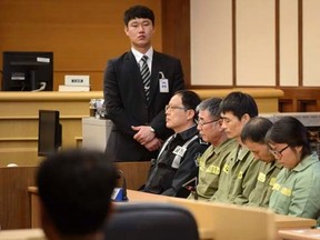 Sewol ferry captain Lee Joon-seok (3rd R) sits with crew members at the start of the verdict proceedings in a court room in Gwangju November 11, 2014.  REUTERS/Ed Jones/Pool